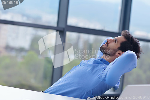 Image of happy young business man at office