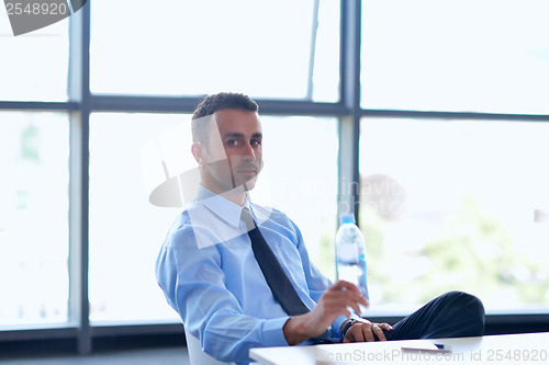 Image of happy young business man at office