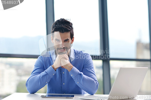 Image of happy young business man at office