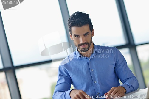 Image of happy young business man at office
