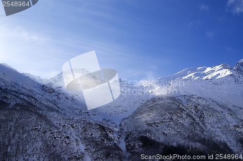 Image of Snowy sunlight mountains, view from ski slope