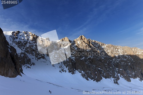 Image of Hikers on snowy mountains in morning