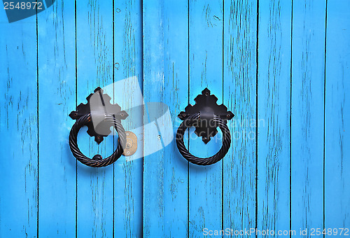 Image of Blue wooden door with round handles