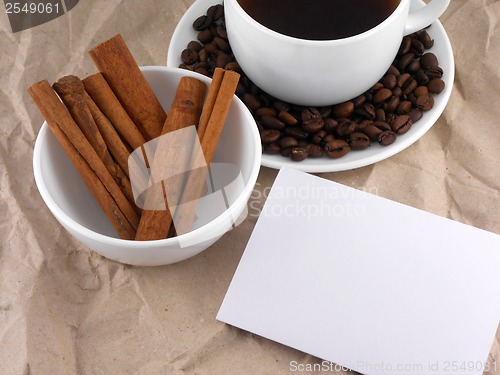 Image of cup of cappuccino with cinnamon and coffee beans