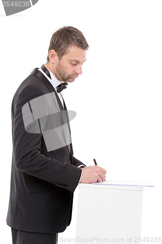 Image of Man in a bow tie completing a form