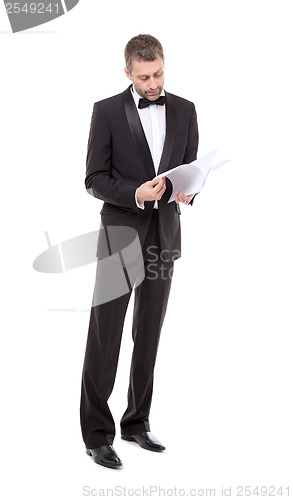 Image of Man in a tuxedo reading the document