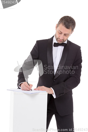 Image of Man in a bow tie completing a form