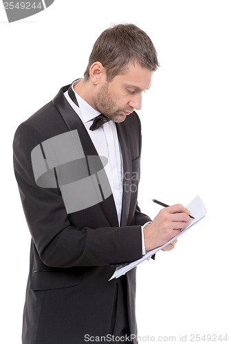 Image of Handsome man in a bow tie writing notes