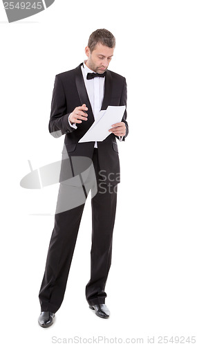 Image of Man in a tuxedo reading the document