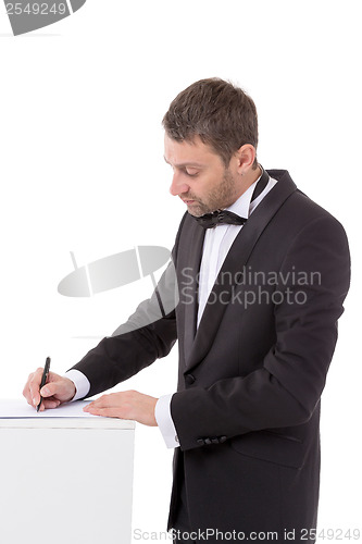 Image of Man in a bow tie completing a form