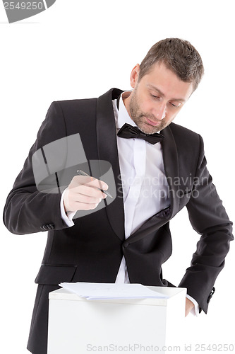 Image of Man in a bow tie completing a form