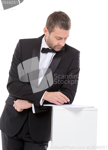 Image of Man in a bow tie completing a form