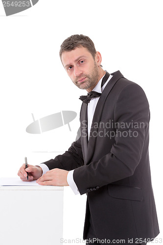 Image of Man in a bow tie completing a form