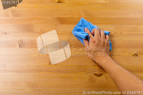 Image of Cleaning table by hand