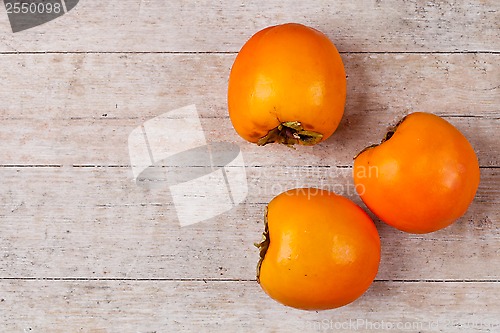 Image of three fresh persimmons 