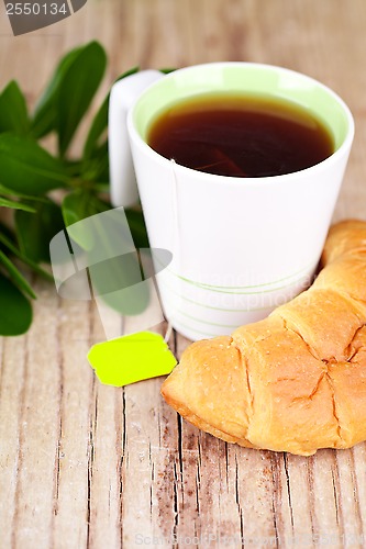 Image of cup of tea and fresh croissant 