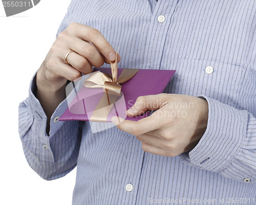 Image of Young man holding a present
