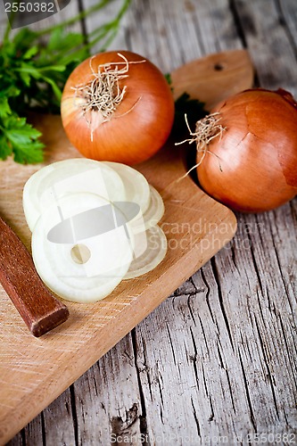 Image of fresh onions, knife, and parsley 