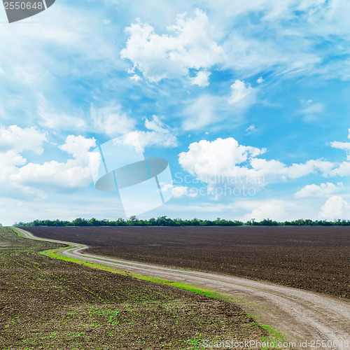 Image of winding rural road under dramatic sky