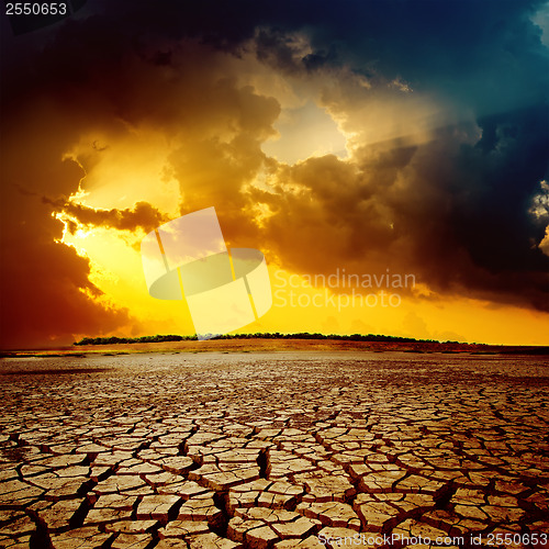 Image of sunset over cracked desert