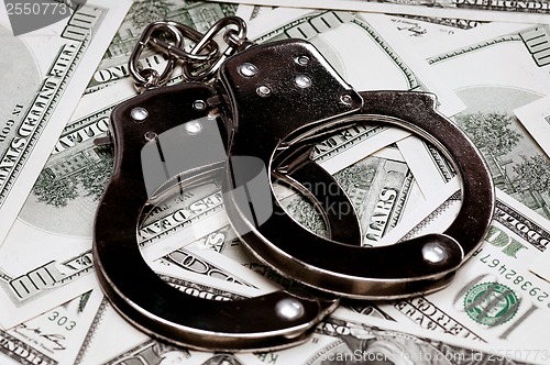 Image of Dollars and handcuffs