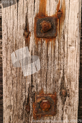 Image of Rusty bolts against old timber 