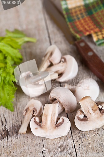 Image of  fresh champignons and old knife 
