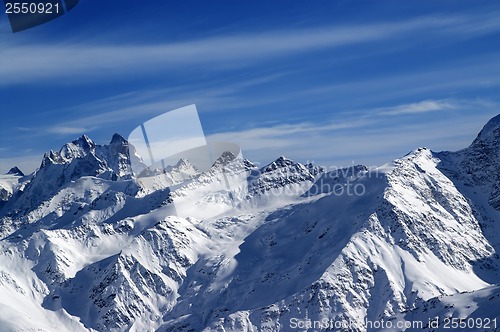 Image of Snowy sunlight mountains, view from ski slope 