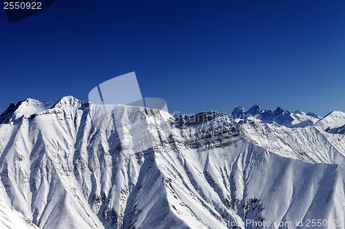 Image of Snowy winter rocks in sun day