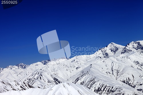 Image of Winter snowy mountains and blue sky