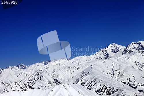 Image of Winter snowy mountains and blue sky