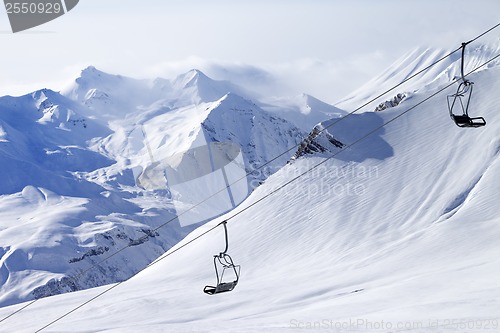 Image of Chair lifts and off-piste slope in haze