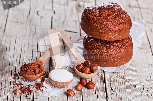 Image of fresh baked browny cakes, milk, sugar, hazelnuts and cocoa powde