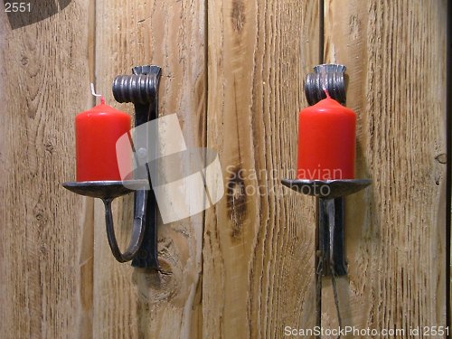 Image of couple of red candles in their holders