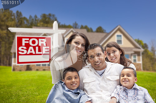 Image of Hispanic Family, New Home and For Sale Real Estate Sign