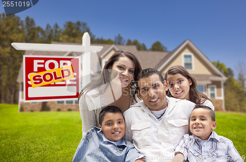 Image of Hispanic Family, New Home and Sold Real Estate Sign