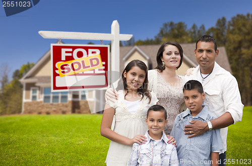 Image of Hispanic Family, New Home and Sold Real Estate Sign