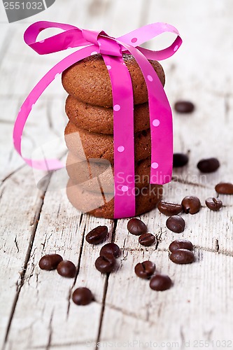 Image of stack of chocolate cookies tied with pink ribbon and coffee bean