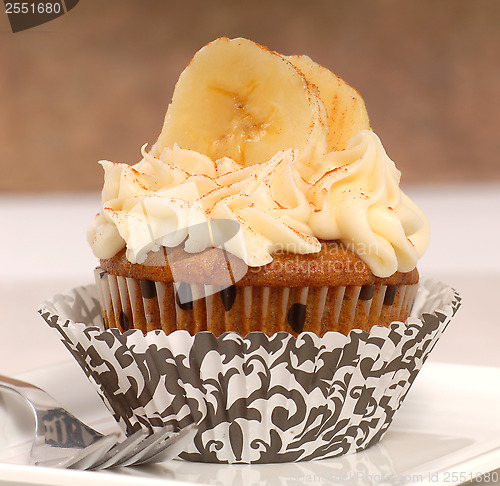 Image of Delicious carrot cake cupcake with cream cheese frosting, sliced