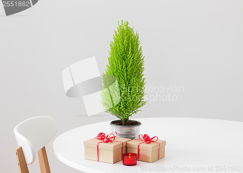 Image of Little Christmas tree and gifts on a table
