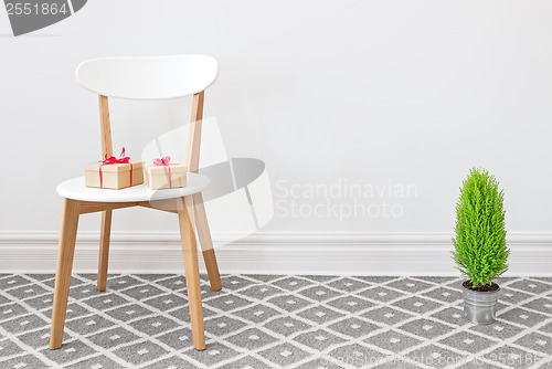 Image of Presents on a white chair, and little green tree