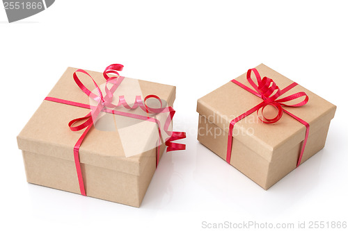 Image of Two gift boxes with red ribbons on white background
