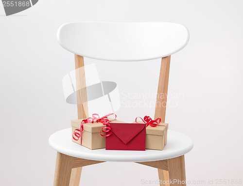 Image of Gifts and red envelope on a wooden chair