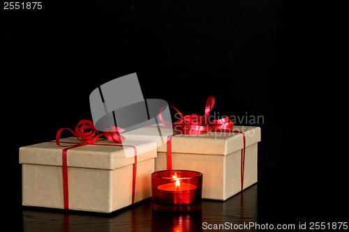 Image of Elegant presents and red candlelight