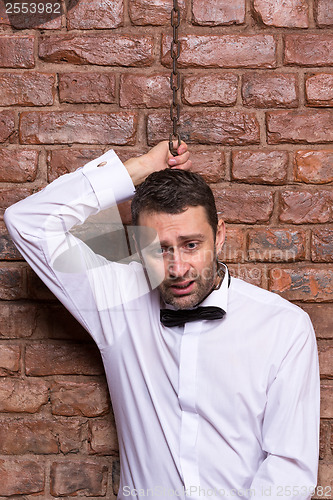 Image of Desperate man with a chain around his neck