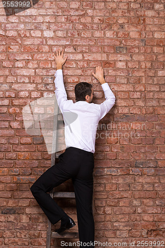 Image of Man up against a brick wall