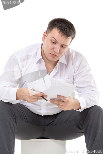 Image of Businessman reading a report with scepticism