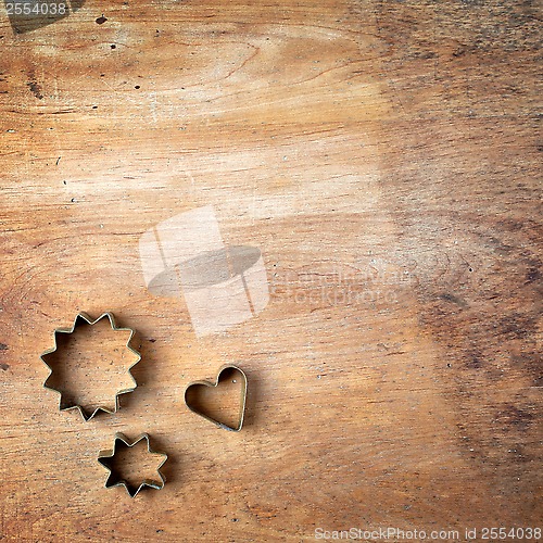 Image of pastry cutters on wooden cutting board