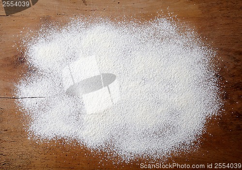 Image of white flour on wooden table