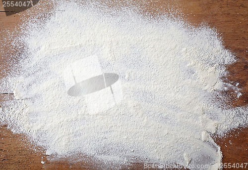 Image of white flour on wooden table